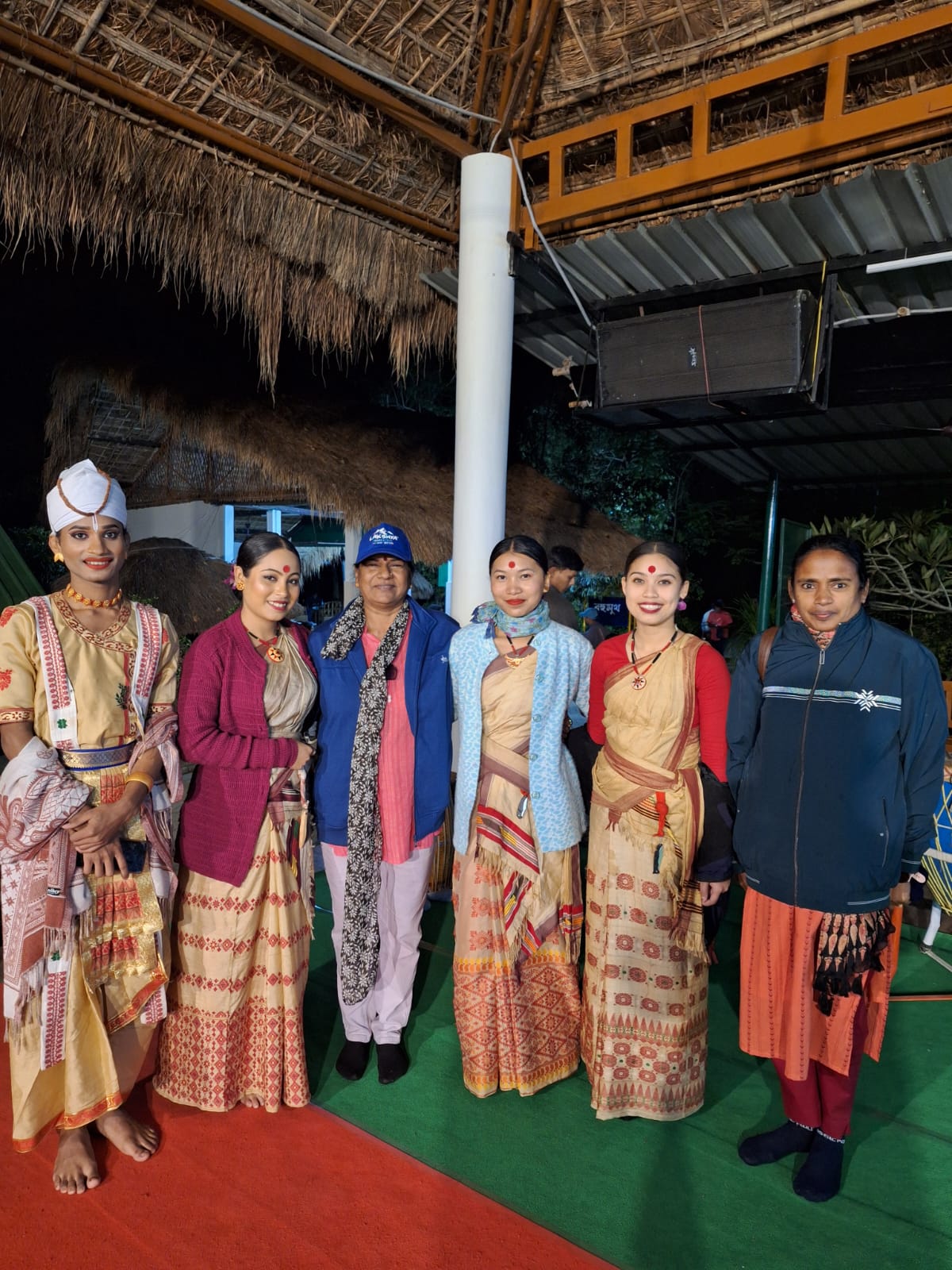 Members of the Kerala group posing with Assamese Bihu and Sattriya performers in traditional attire on board the Brahmaputra river cruise in Guwahati