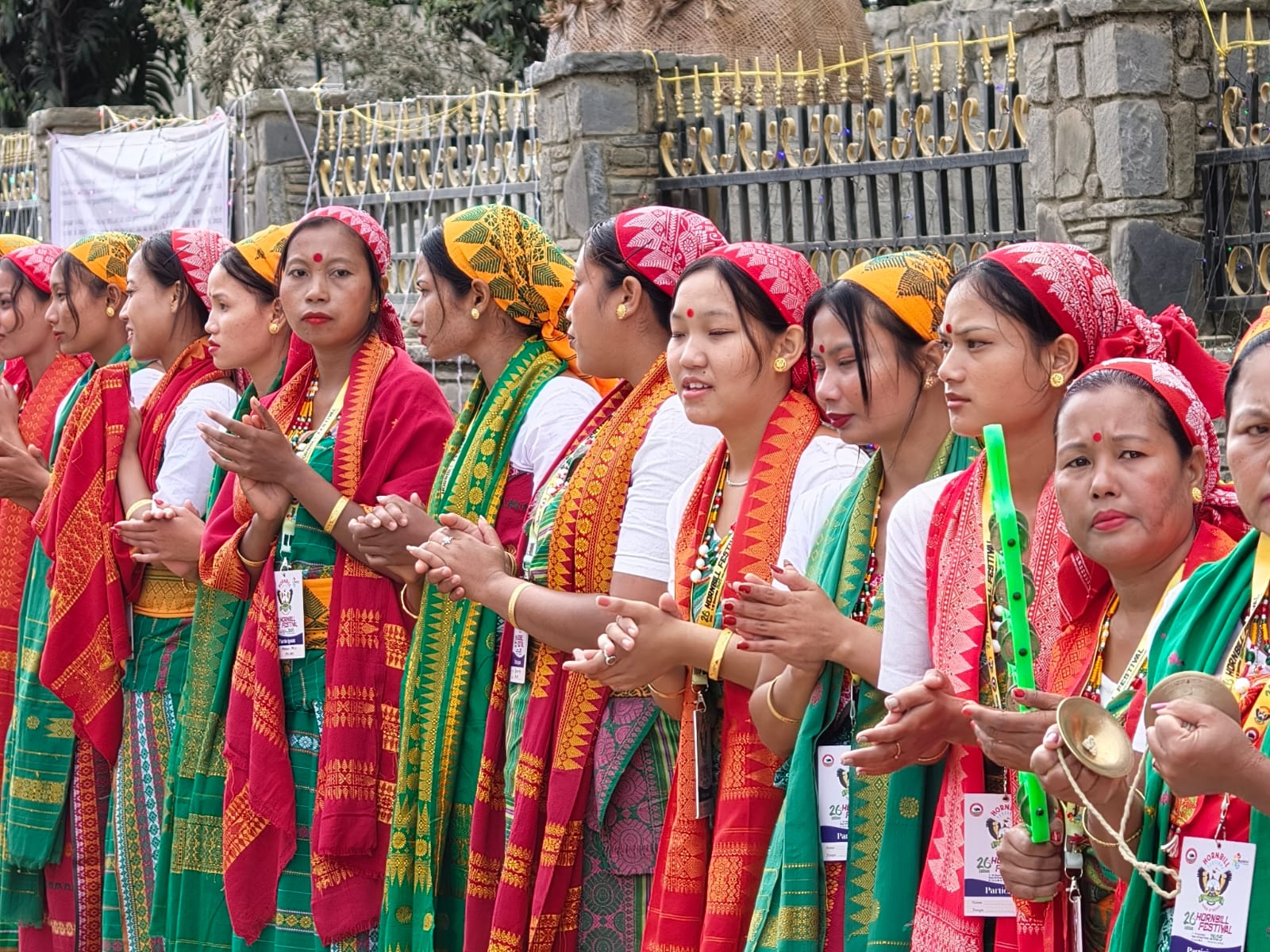 Women in red and green traditional shawls at the Hornbill Festival at Kisama