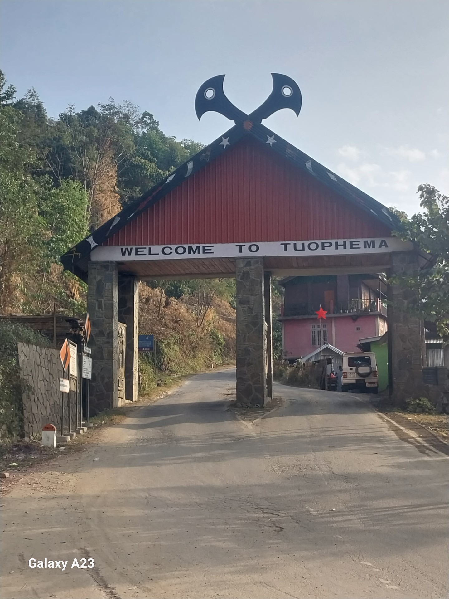 The wooden welcome gate to Touphema heritage village in Nagaland with crossed mithun-horn motifs