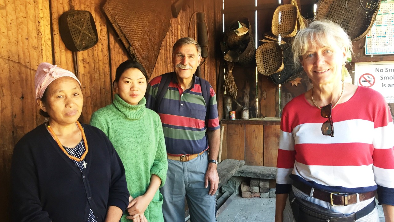 Mr. Gulder and his wife inside a traditional Naga house with their two local hostesses at Touphema Tourist Village, Nagaland