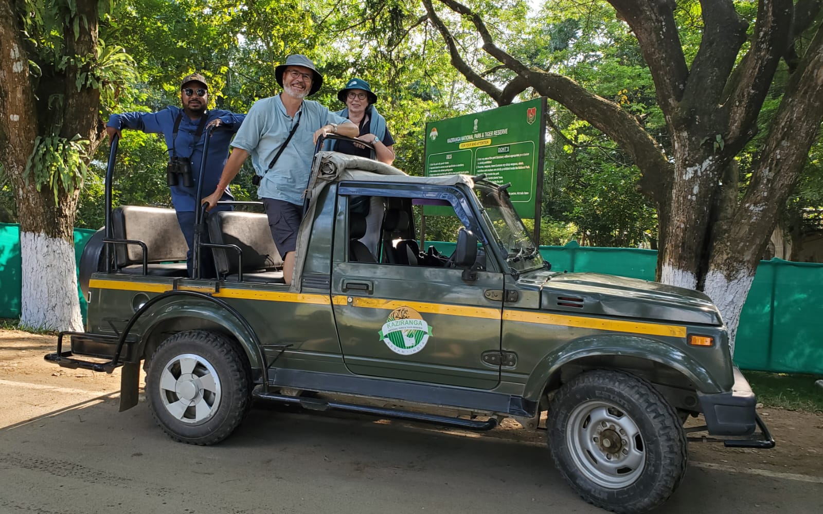 Robert and Odile with their naturalist in an open safari jeep at the entrance of Kaziranga National Park, Assam